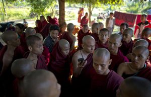 Buddhist monks, some of who escape from the security forces crack down, listen to radio news cast from a monastery in Monywa, northwestern Myanmar, Thursday, Nov. 29, 2012 (AP)