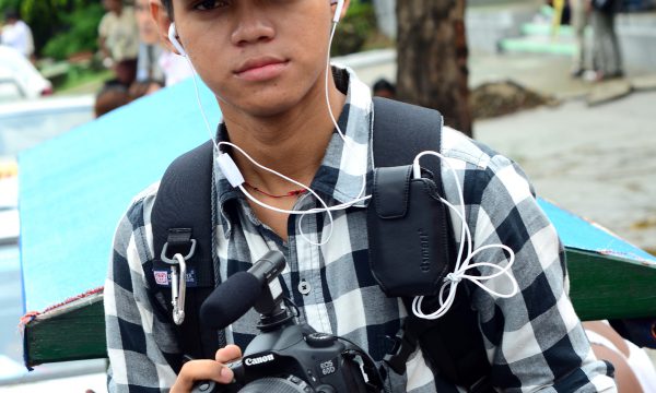 young man with RFA hat and a camera