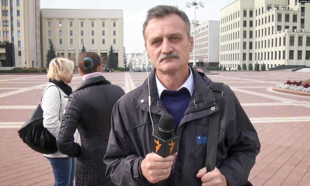 man on the street holding microphone and reporting